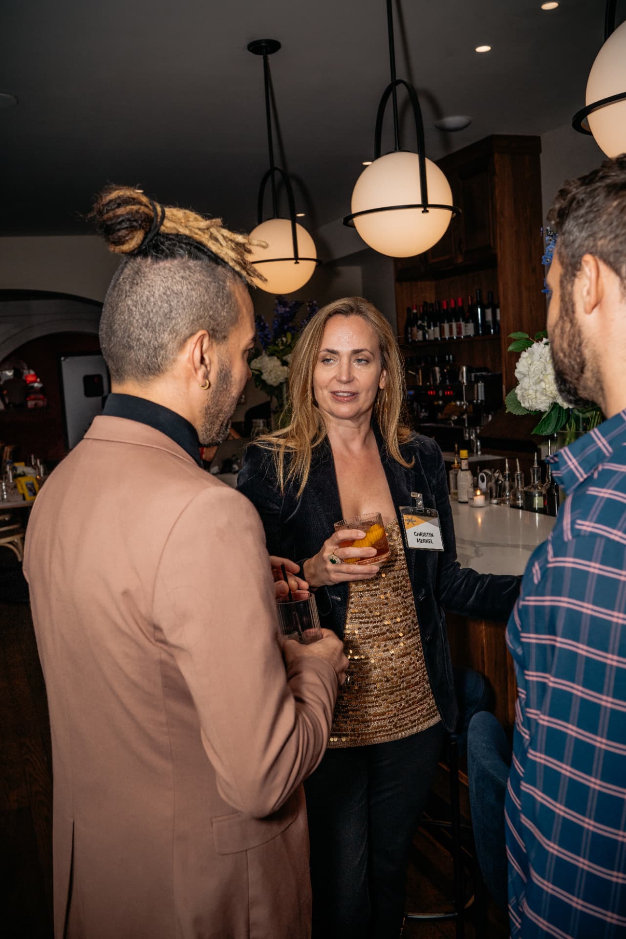 Two leaders in candid conversation over drinks at the bar after a session